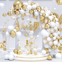 a white and gold birthday party with balloons