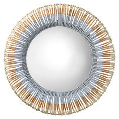 a round mirror with wooden sticks in the shape of a sunburst on it