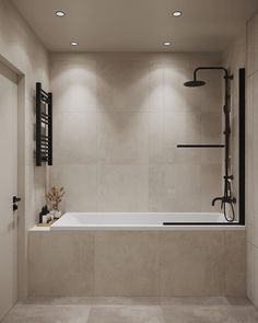 a bathroom with a bathtub, shower head and two lights on the wall above it