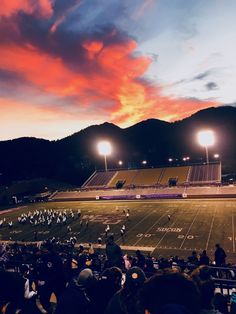 an empty football field with people watching it