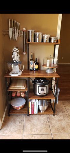 a kitchen area with shelves, pots and pans