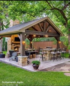 an outdoor kitchen and grill area in the backyard