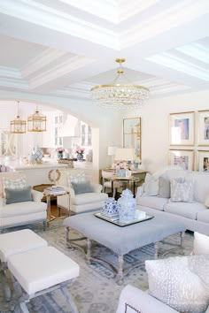 a living room filled with lots of white furniture