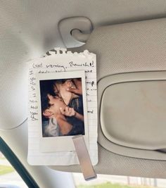 the back seat of a car with a photo hanging from it's side window