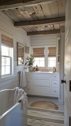 a bathroom with a tub, sink and window