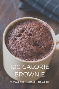 a close up of a cup of coffee on a table with the words, 100 calorie brownie