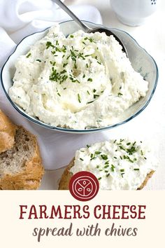 a bowl filled with mashed potatoes next to two bagels on a white table