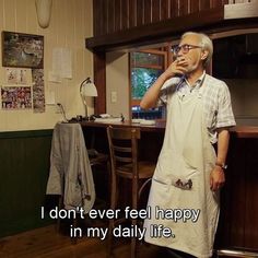 an older man standing in front of a kitchen counter talking on a cell phone with the caption i don't ever feel happy in my daily life