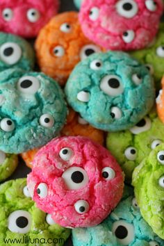 colorful cookies with gooey monster eye eyes on them are ready to be eaten for halloween