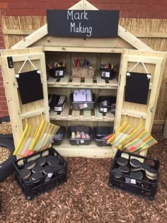 an outdoor market with lots of items for sale on the shelves and in front of it is a sign that says mark making