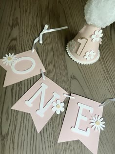 some pink and white decorations on a wooden table