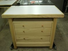 a workbench with drawers on wheels in a shop