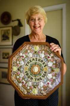 an older woman is holding up a decorative plate with the words, it's supple birthday written on it