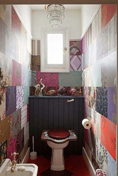 the bathroom is decorated with colorful wallpapers and a chandelier hanging from the ceiling