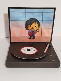 a record player with an image of a cartoon character playing the guitar on it's turntable