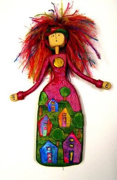 a colorful doll hanging from the side of a wall