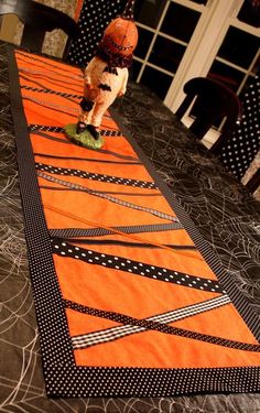 an orange table runner with black and white designs