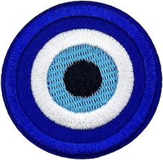 a blue and white patch with an eyeball on it