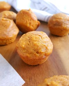 some muffins are sitting on a wooden table