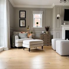 a living room filled with furniture and a flat screen tv mounted on the wall above a fireplace