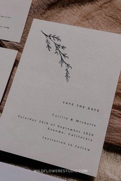 the wedding stationery is laid out on top of each other