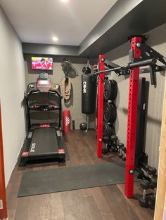 a home gym is shown with equipment in the corner