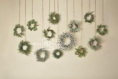 a group of wreaths hanging from the ceiling next to each other on a wall