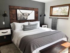 a bedroom with a bed, nightstands and pictures on the wall above it's headboard