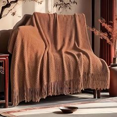 a brown blanket sitting on top of a wooden chair