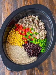 the ingredients for this meal are mixed together in a bowl on top of a wooden table