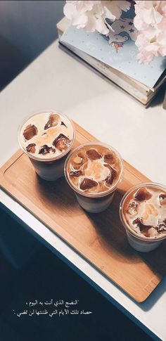 three desserts sitting on top of a wooden cutting board