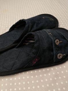 an open pair of jeans sitting on top of a bed