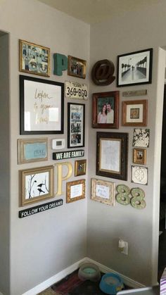 a wall filled with lots of framed pictures and other things on it's side