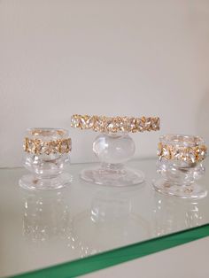 three different sized rings sitting on top of a glass table