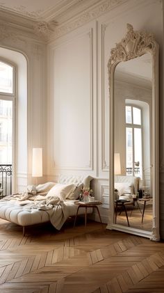 a living room filled with furniture and a large mirror on the wall next to it