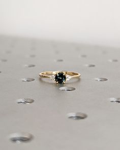 a close up of a ring on top of a table with drops of water around it