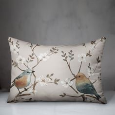 a pillow with two birds on it