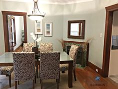 a dinning room table and chairs in front of a fireplace