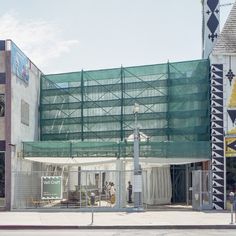 a large building with scaffolding on the side of it's front entrance