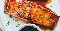 grilled salmon with sauce on a white plate