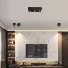 a living room with marble furniture and a flat screen tv mounted on the wall above it