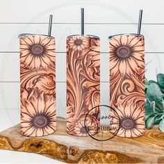 three lighters sitting next to each other on top of a wooden table with a plant in the background