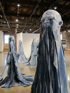 several pieces of clothing are on display in an art gallery