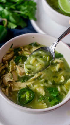 a white bowl filled with soup and green vegetables