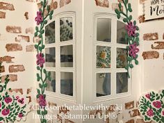 the window is decorated with flowers and leaves