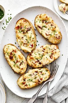 baked potatoes with cheese and herbs on a white plate