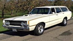 an old station wagon is parked on the side of the road