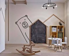 a child's room with a chalkboard wall and rocking chair in the foreground