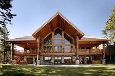 a large wooden house surrounded by trees and grass