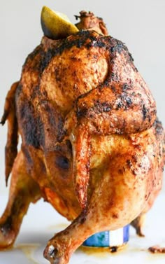 a whole chicken sitting on top of a blue and white plate